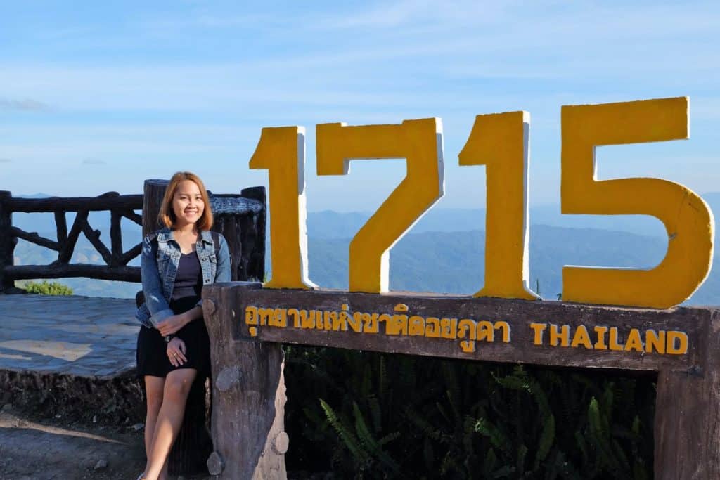 Judy at the 1715 viewpoint in Doi Phu Kha National Park in Thailand with a wide view of the landscape.