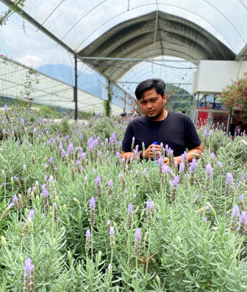 The picture shows Akmal in a field of lavender.